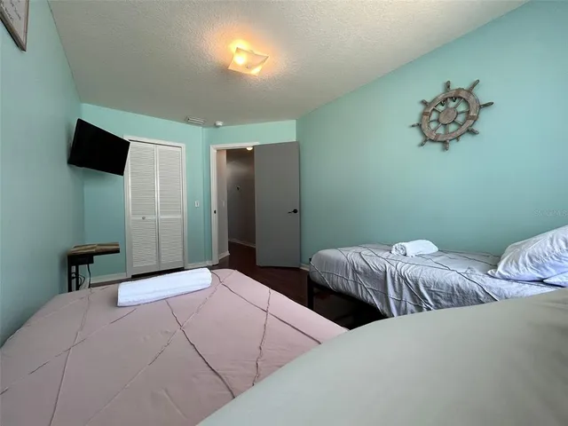 a bedroom with bed and a wall painting