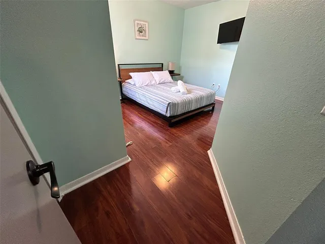 a living room with hard wood floors and a wooden floor
