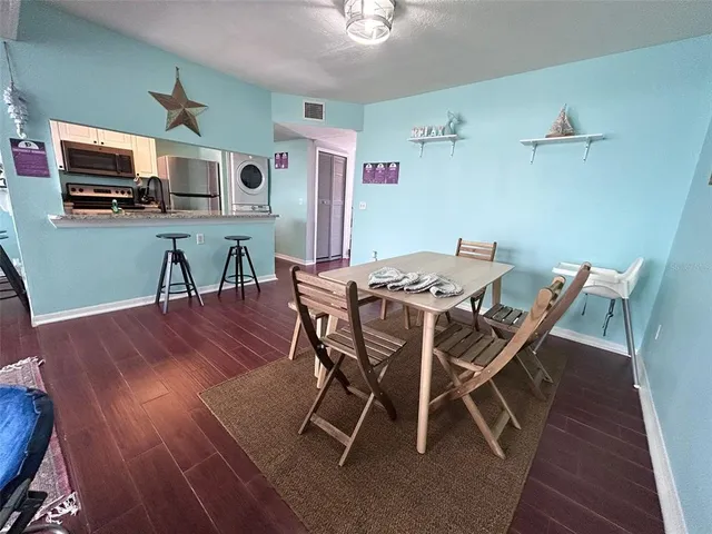 a view of a dining room with furniture and wooden floor
