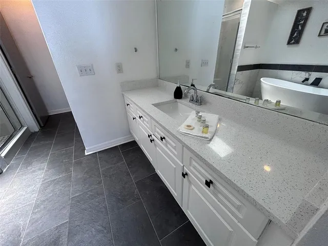 a bathroom with a double vanity sink and a mirror