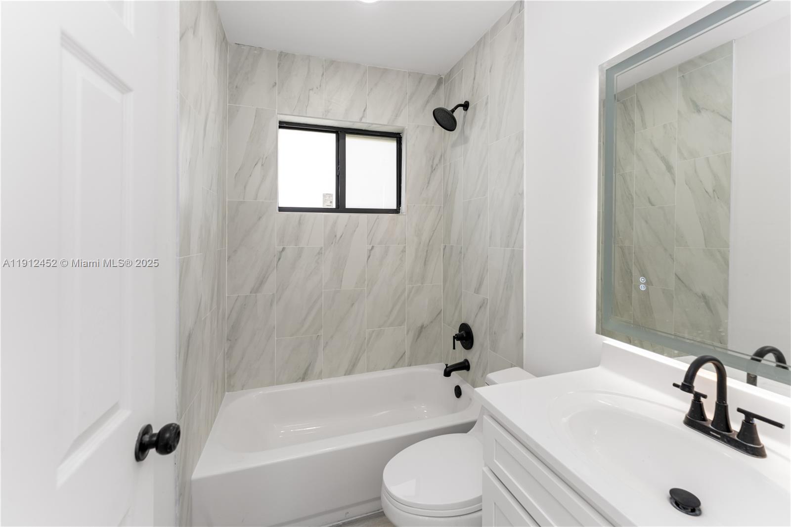 11532 Southwest 136th Terrace Miami, FL 33176 - Photo 17 of 20 a bathroom with a sink a toilet and a bathtub