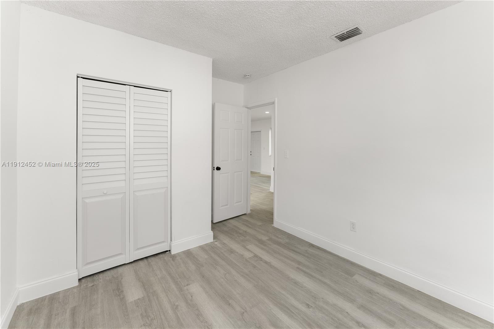 11532 Southwest 136th Terrace Miami, FL 33176 - Photo 19 of 20 an empty room with wooden floor