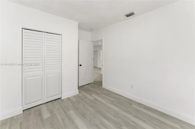 an empty room with wooden floor