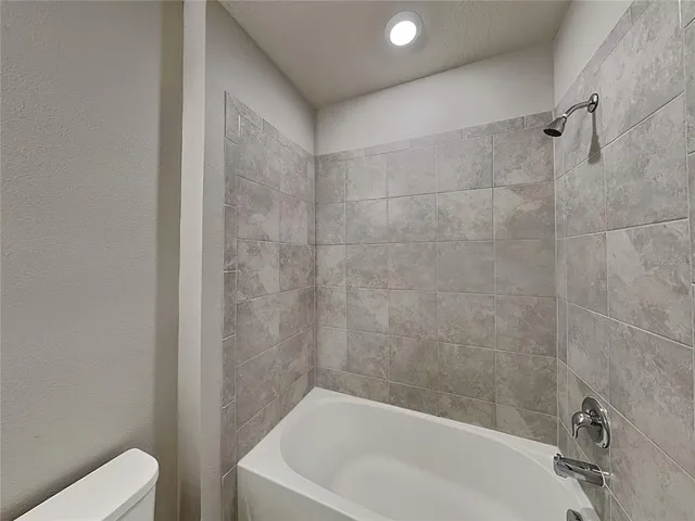 a bathroom with a bathtub and a toilet