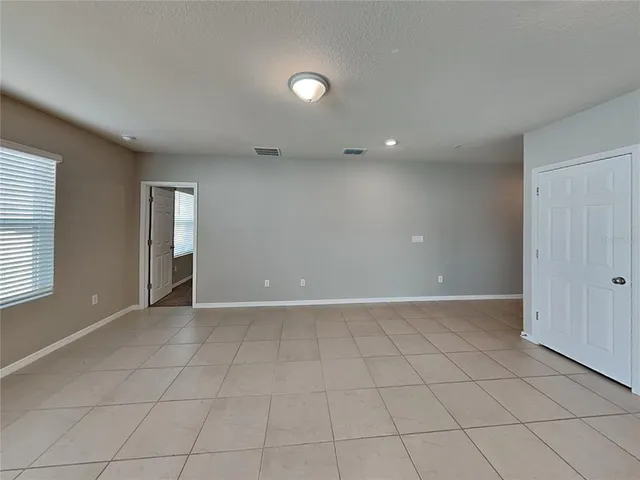 an empty room with windows and entrance