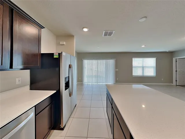 a kitchen with stainless steel appliances a refrigerator and a stove top oven