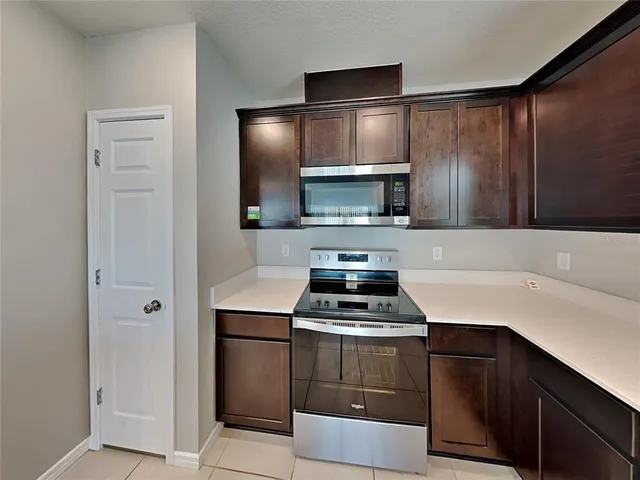 a kitchen with a sink appliances and cabinets