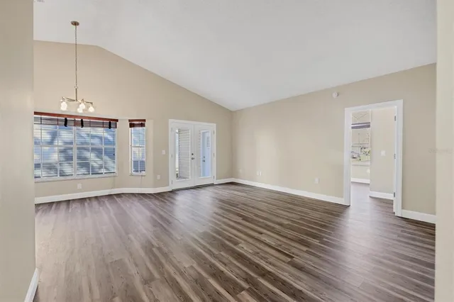a view of an empty room with wooden floor