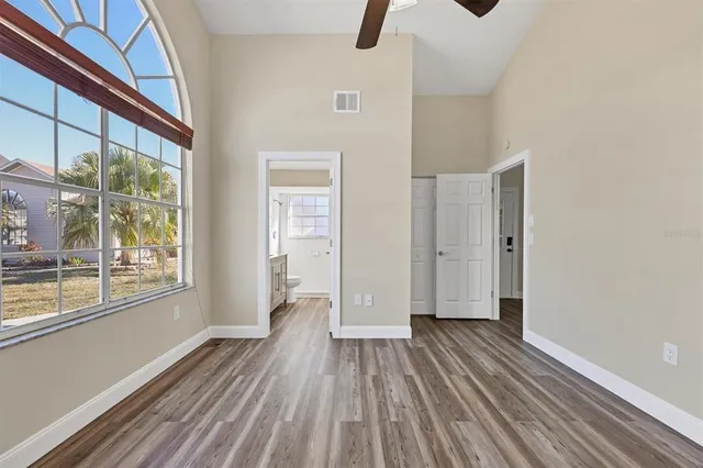 a view of a room with wooden floor and windows