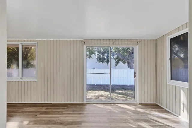 a view of a livingroom with wooden floor and window