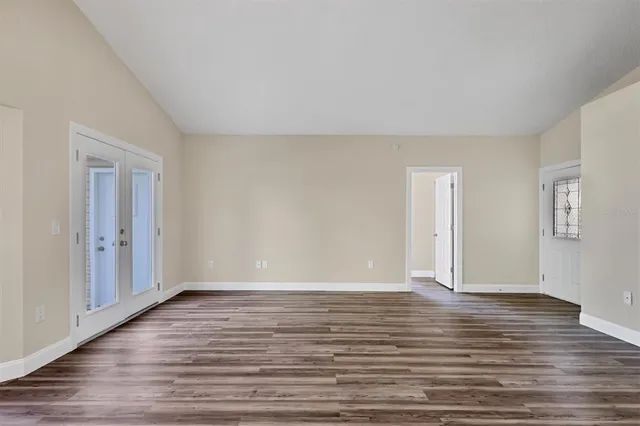 a view of an empty room with wooden floor