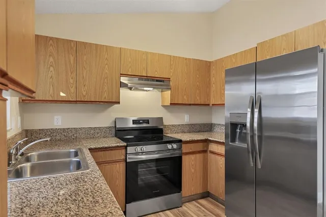 a kitchen with a stove and a refrigerator