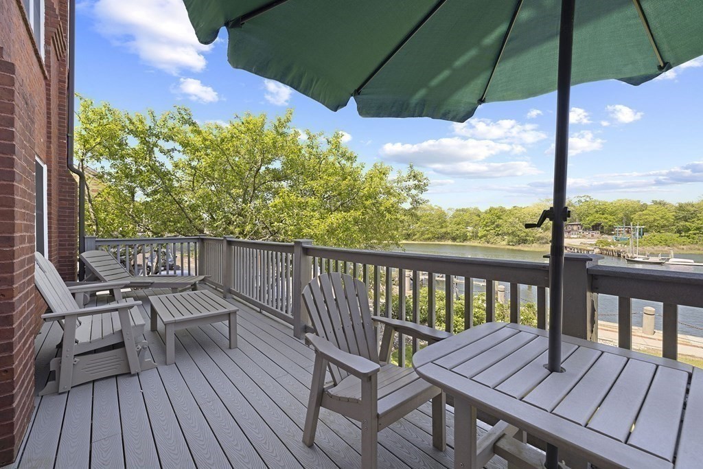 45 Main Street, Unit 111 Wareham, MA 02571 - Photo 16 of 20 a view of a balcony with wooden floor and outdoor seating