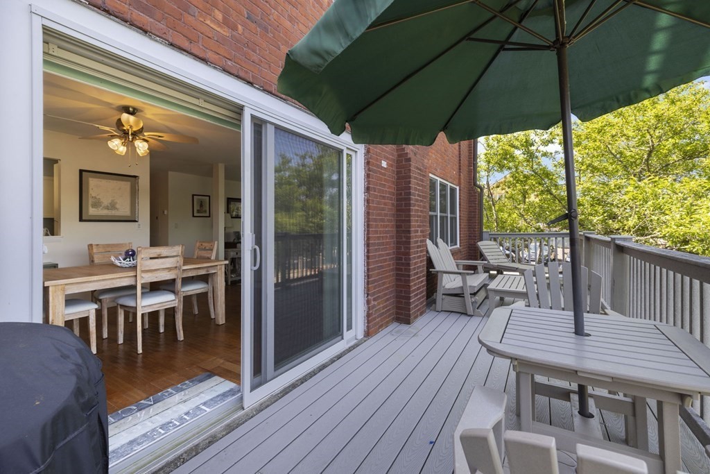 45 Main Street, Unit 111 Wareham, MA 02571 - Photo 17 of 20 a view of a dinning table and chairs in the balcony
