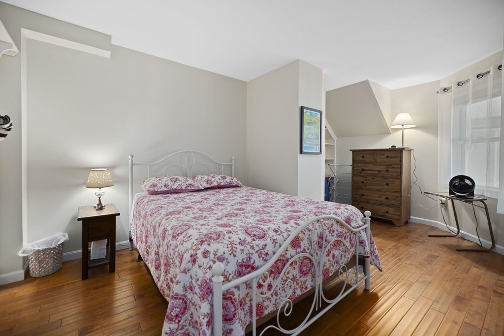 45 Main Street, Unit 111 Wareham, MA 02571 - Photo 3 of 20 a bedroom with a bed and wooden floor