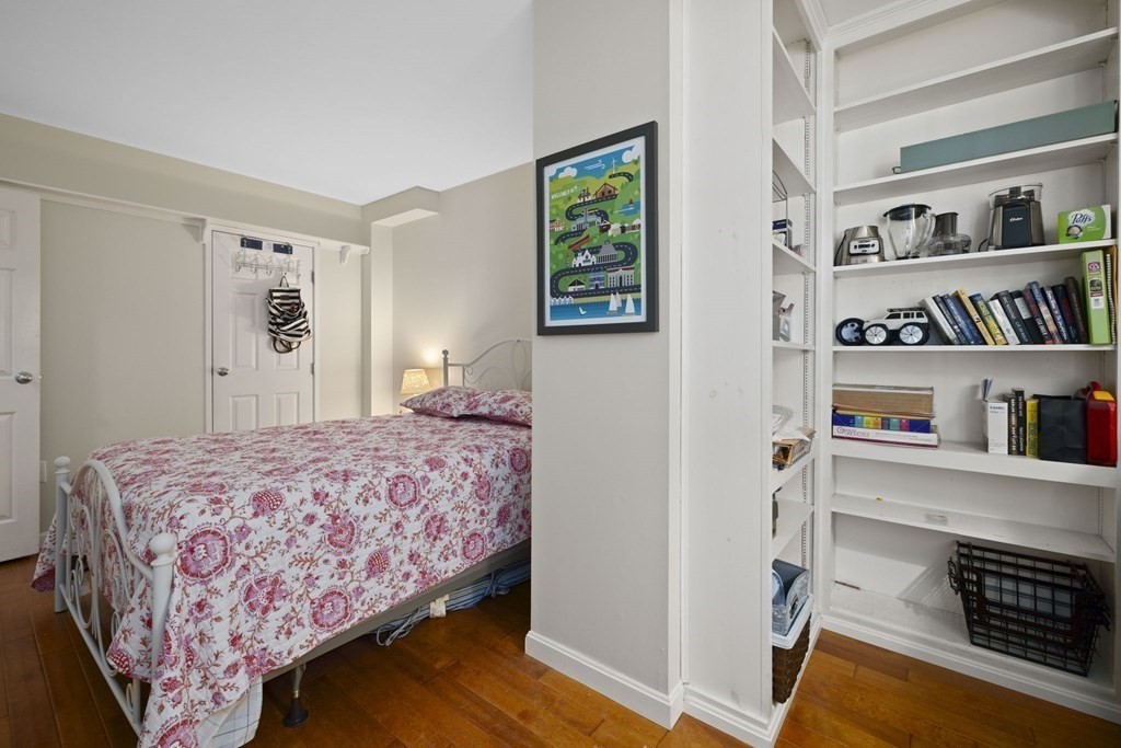 45 Main Street, Unit 111 Wareham, MA 02571 - Photo 4 of 20 a bedroom with a bed and a book shelf