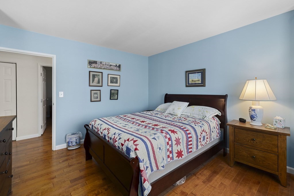 45 Main Street, Unit 111 Wareham, MA 02571 - Photo 6 of 20 a bedroom with a bed and wooden floor