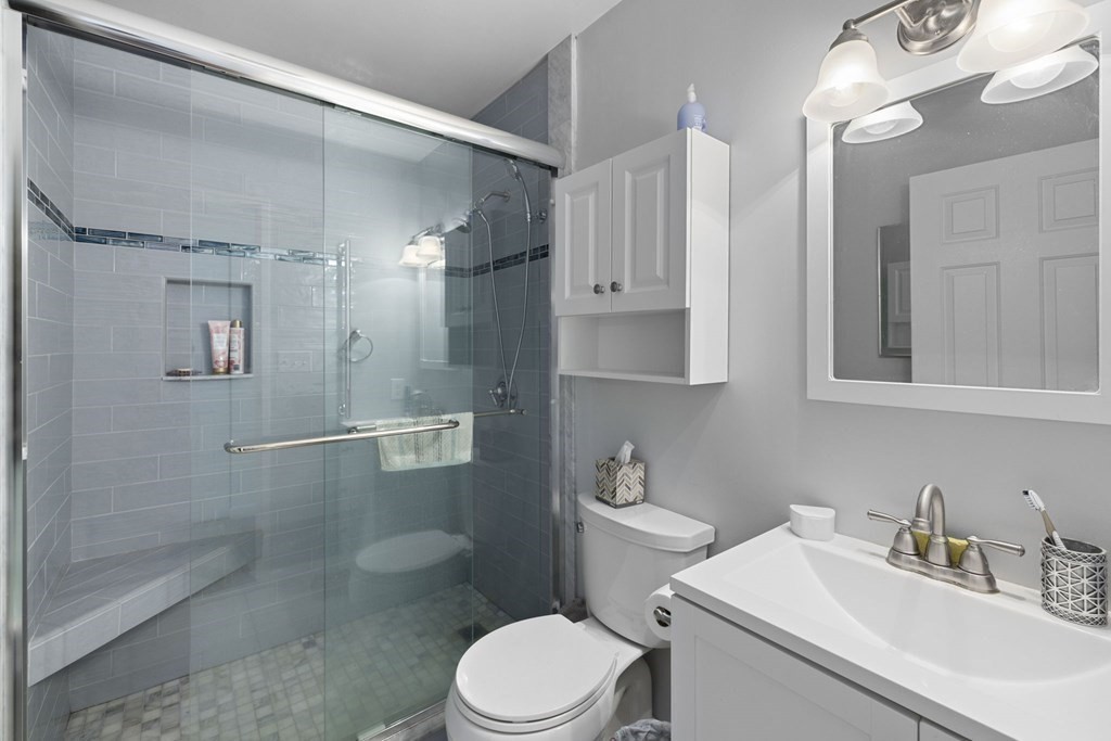 45 Main Street, Unit 111 Wareham, MA 02571 - Photo 7 of 20 a bathroom with a sink vanity granite toilet and shower