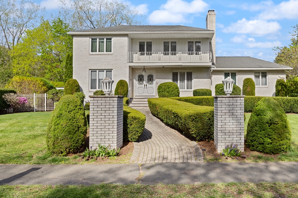34 Coolidge Road Winchester, MA 01890 - Photo 1 of 33 a front view of a house with a yard and garage