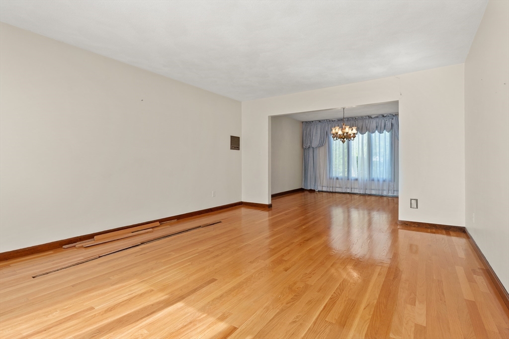 34 Coolidge Road Winchester, MA 01890 - Photo 12 of 33 a view of an empty room with wooden floor and a window