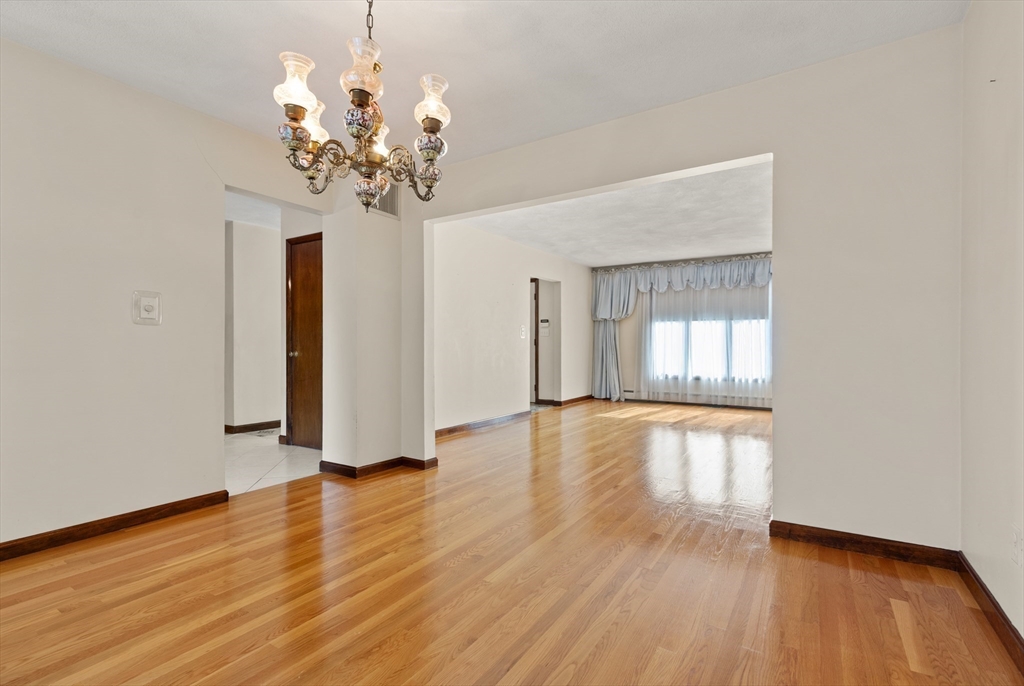 34 Coolidge Road Winchester, MA 01890 - Photo 15 of 33 a view of an empty room with wooden floor and a window