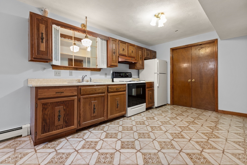 34 Coolidge Road Winchester, MA 01890 - Photo 22 of 33 a kitchen with stainless steel appliances granite countertop a sink and cabinets
