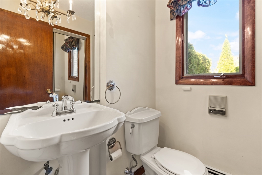 34 Coolidge Road Winchester, MA 01890 - Photo 25 of 33 a bathroom with a sink a mirror and a toilet