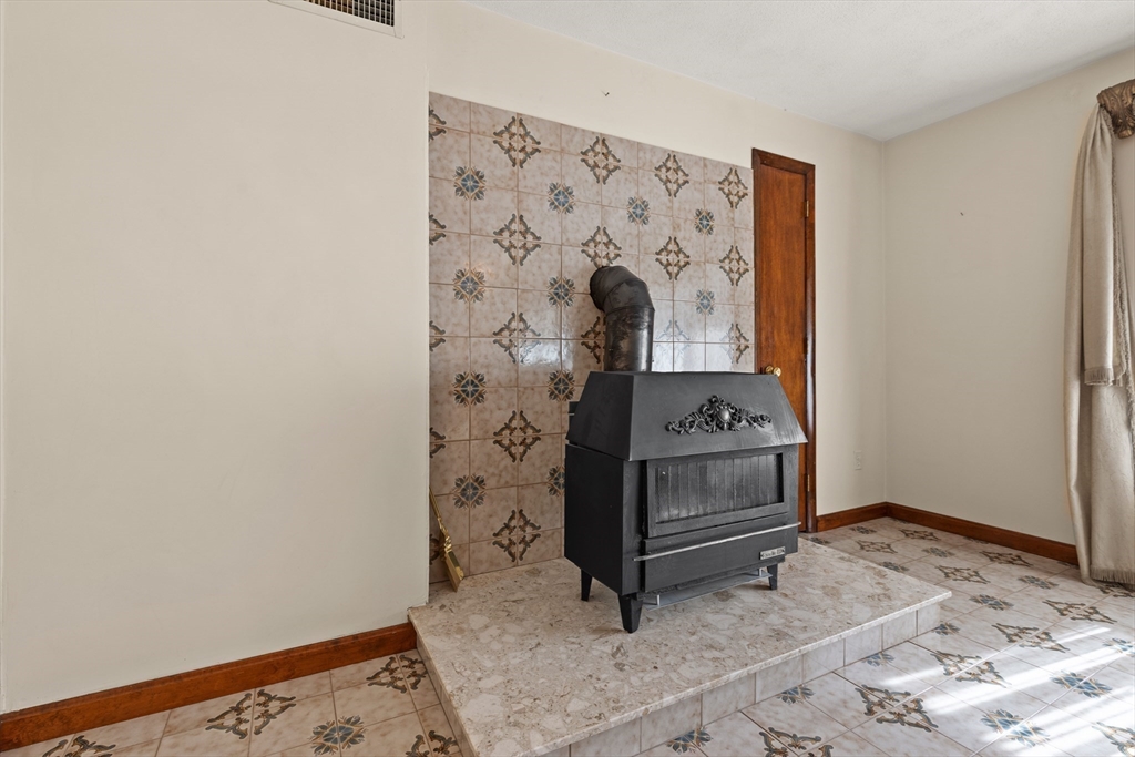 34 Coolidge Road Winchester, MA 01890 - Photo 6 of 33 a room with a stove and a wooden floor