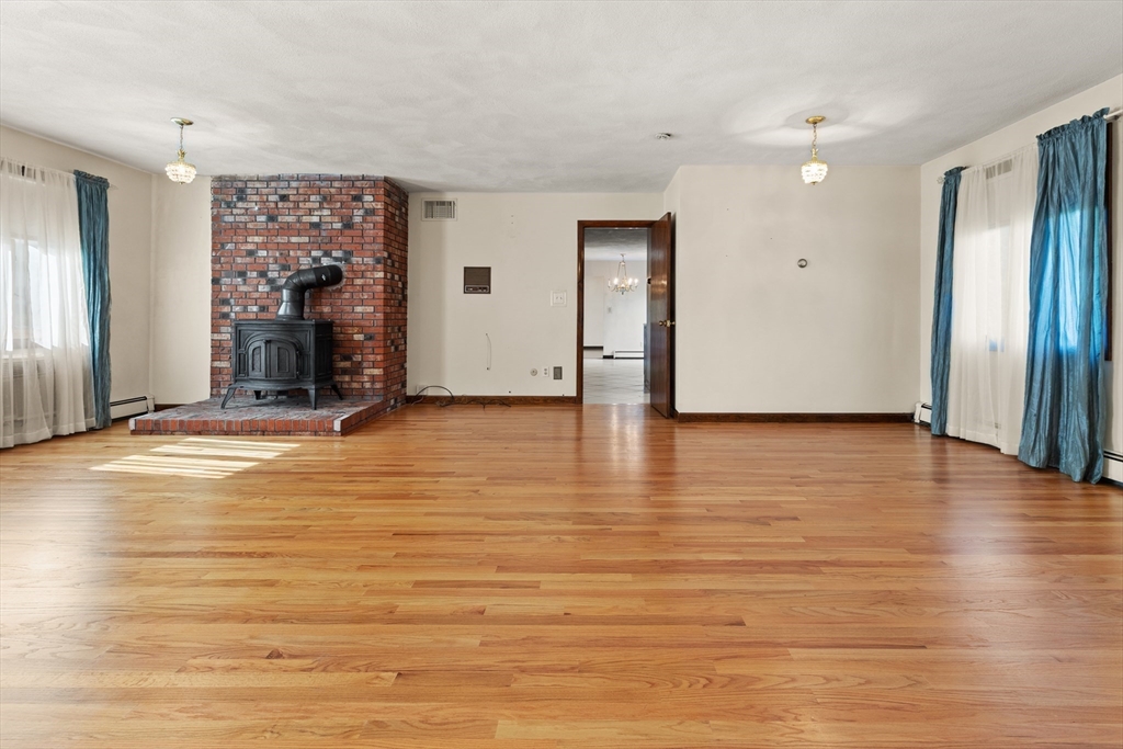 34 Coolidge Road Winchester, MA 01890 - Photo 7 of 33 a view of a livingroom with wooden floor and a fireplace