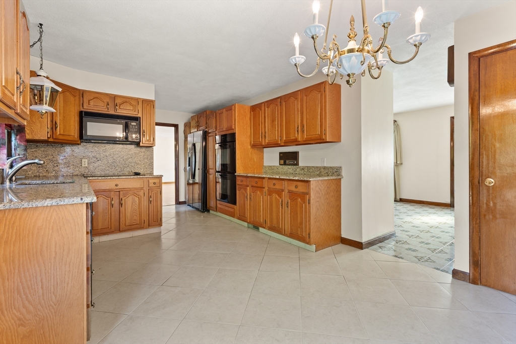 34 Coolidge Road Winchester, MA 01890 - Photo 9 of 33 a kitchen with stainless steel appliances granite countertop a stove a sink a refrigerator and a refrigerator