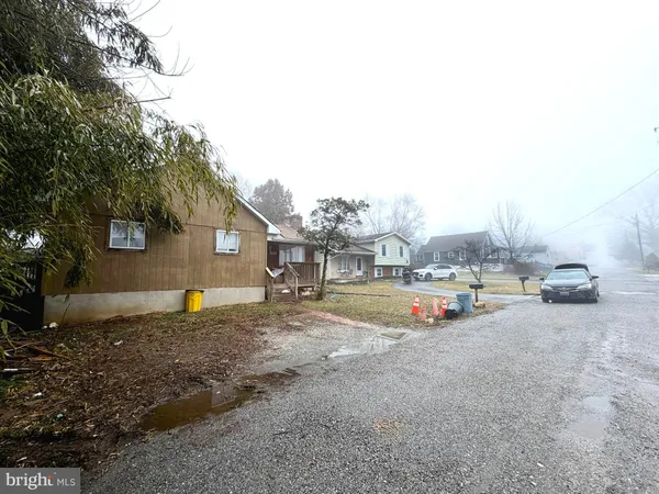 a view of a house with a yard covered in snow