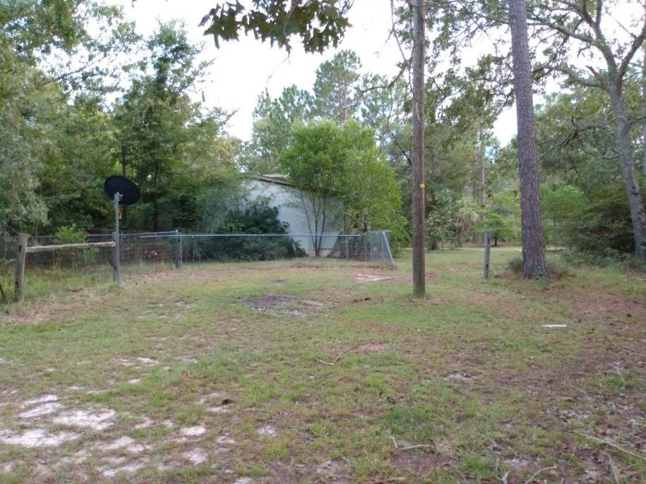 567 Cedar Road Aiken, SC 29803 - Photo 17 of 25 a backyard of a house with lots of green space