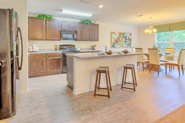 334 Merlin Court Crestview, FL 32539 - Photo 2 of 19 a kitchen with stainless steel appliances granite countertop a stove a sink a refrigerator and a refrigerator