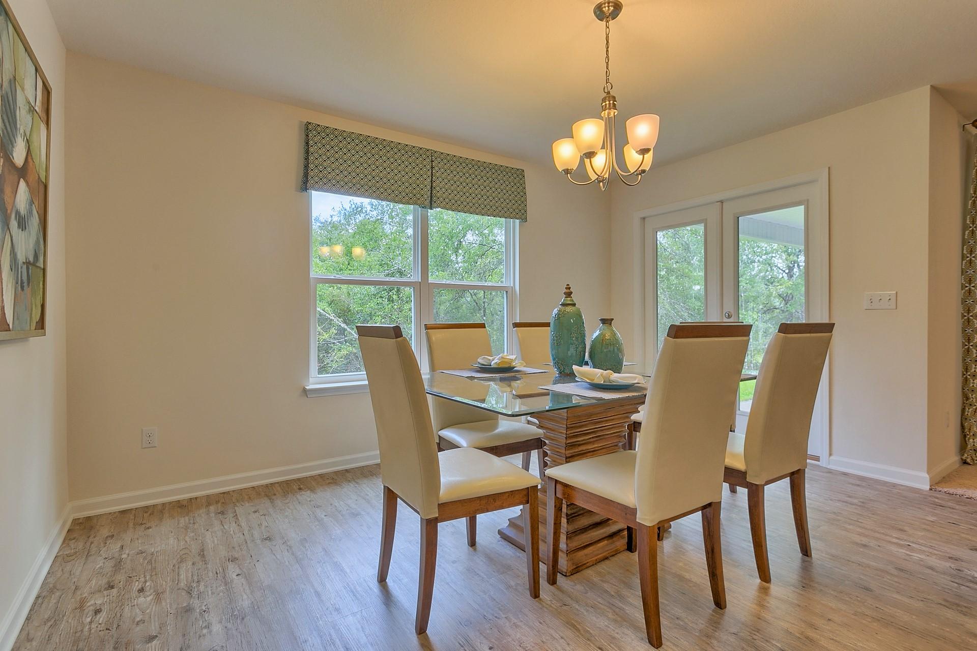 334 Merlin Court Crestview, FL 32539 - Photo 6 of 19 a view of a dining room with furniture window and wooden floor