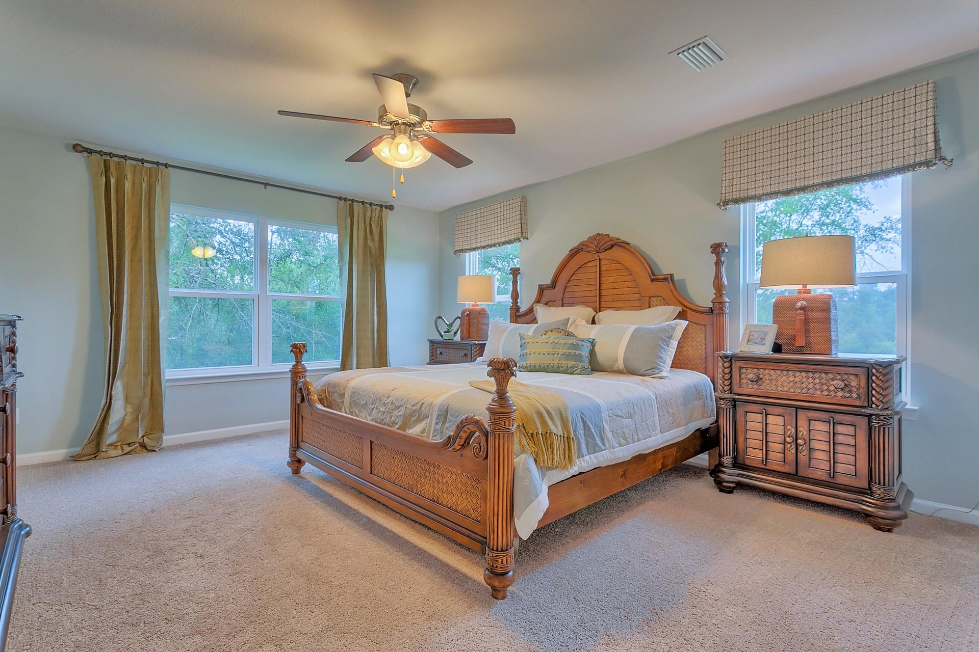 334 Merlin Court Crestview, FL 32539 - Photo 8 of 19 a bedroom with a bed and a chandelier