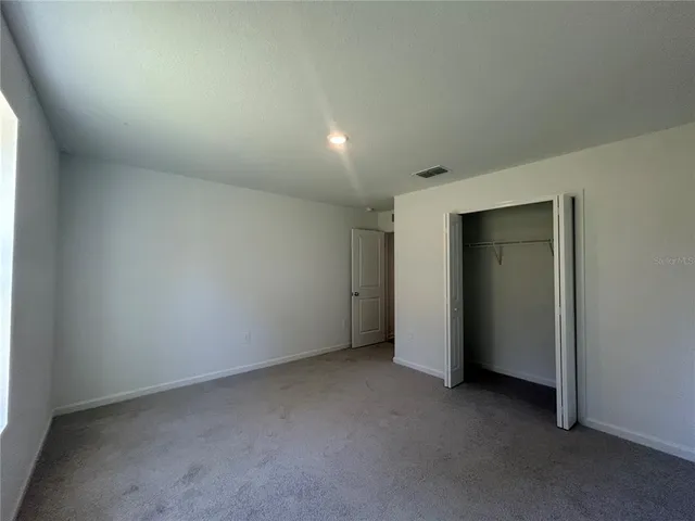 an empty room with closet area