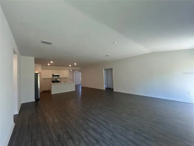 a view of a kitchen with a sink and wooden floor