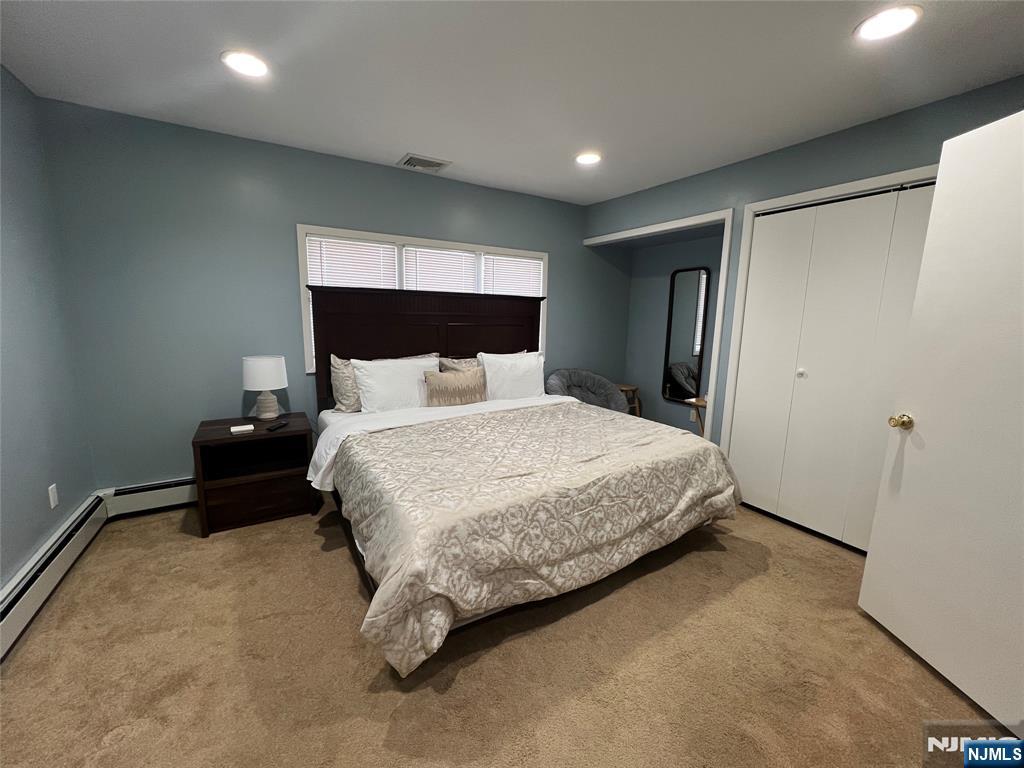 32 Franklin Street Hackensack, NJ 07601 - Photo 5 of 11 a bedroom with a bed and a potted plant