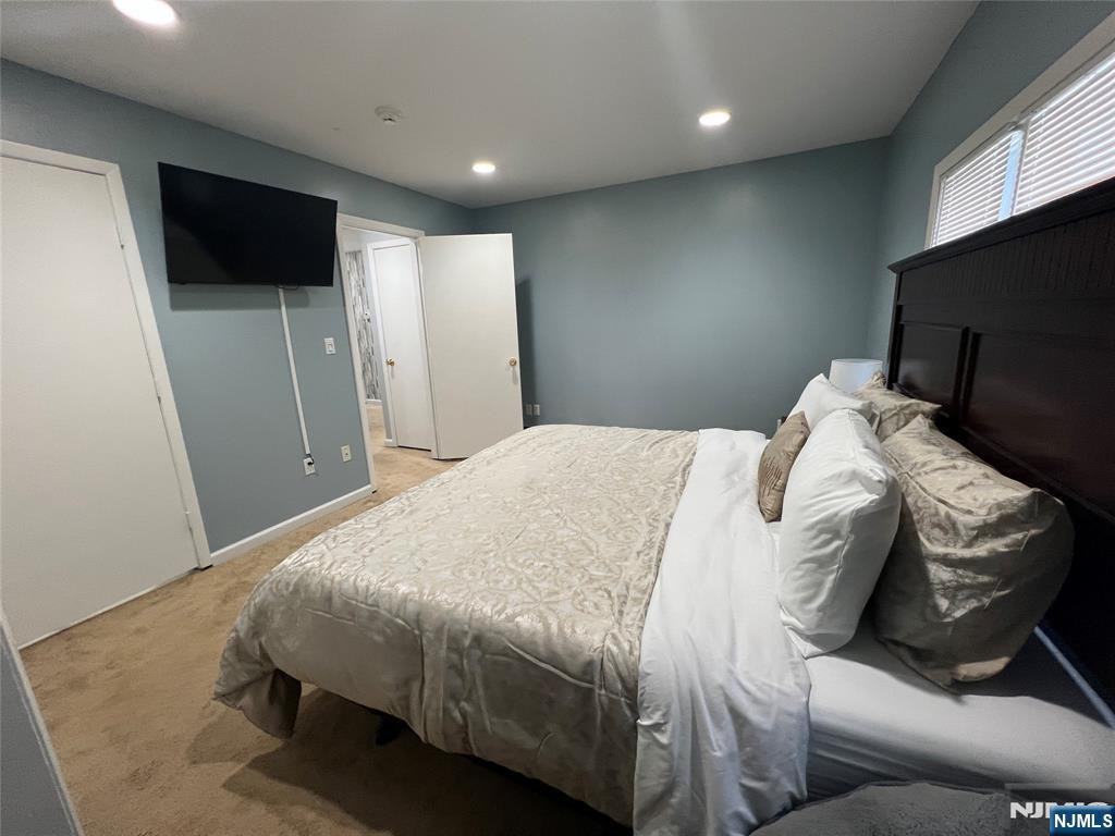 32 Franklin Street Hackensack, NJ 07601 - Photo 6 of 11 a bedroom with a bed and a flat screen tv
