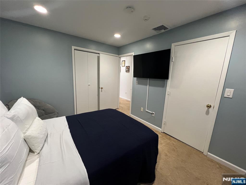32 Franklin Street Hackensack, NJ 07601 - Photo 8 of 11 a bedroom with a bed and a flat screen tv