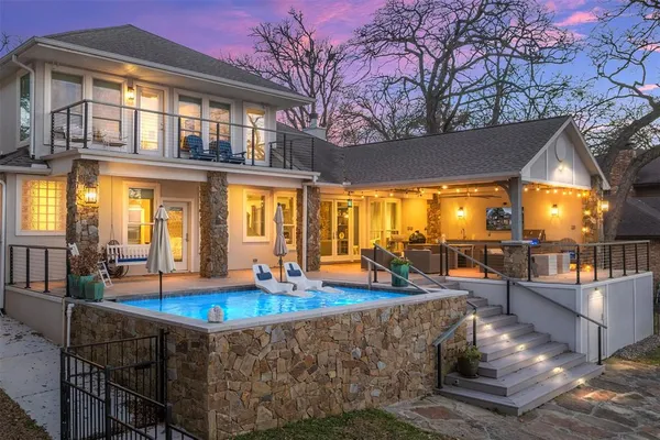 a view of a house with swimming pool and sitting area