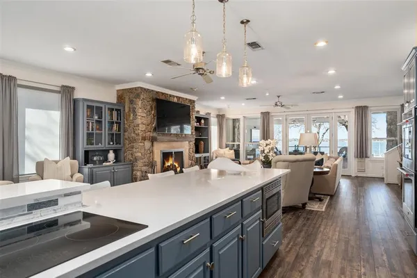 a large kitchen with a large counter top appliances and cabinets