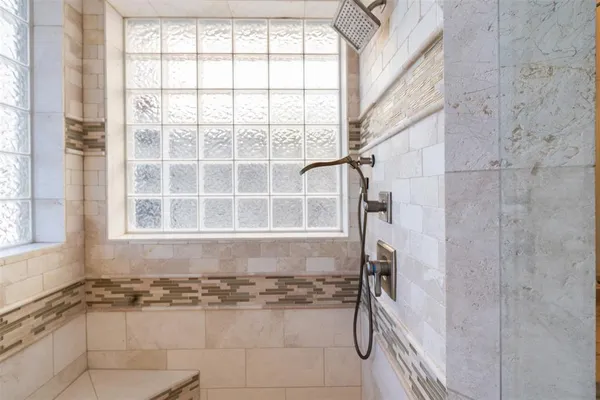 a bathroom with a bathtub and shower
