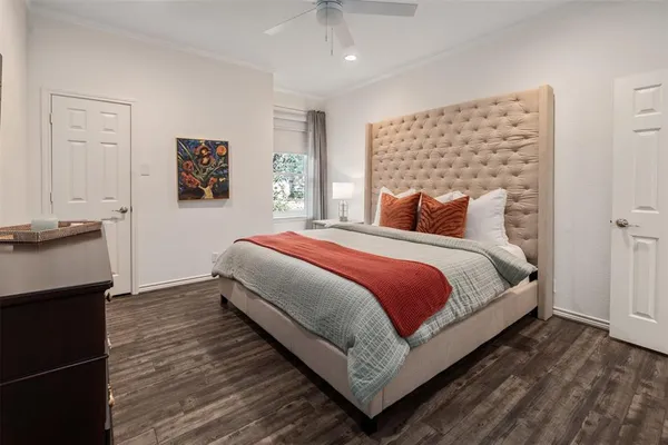 a bedroom with a bed and a painting on the wall