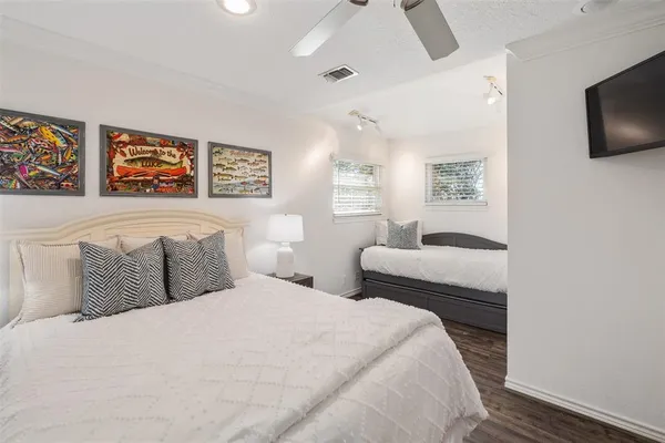 a bedroom with a large bed and a flat screen tv