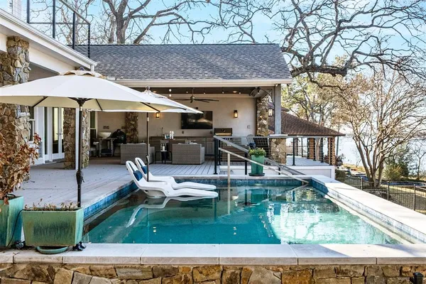 a view of a house with backyard porch and sitting area