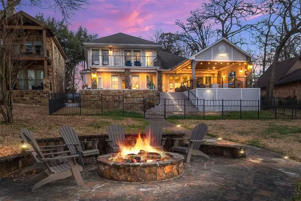 a backyard of a house with yard fire pit and outdoor seating