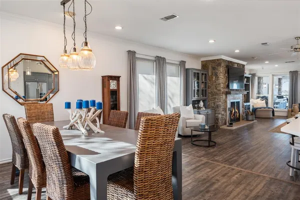 a living room with furniture a chandelier and a dining table