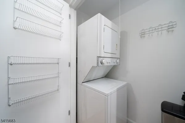 a utility room with cabinets washer and dryer