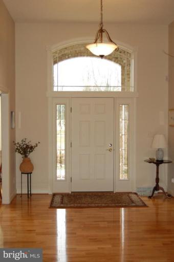 1133 Ragged Edge Road Chambersburg, PA 17202 - Photo 16 of 30 a view of empty room with window and wooden floor
